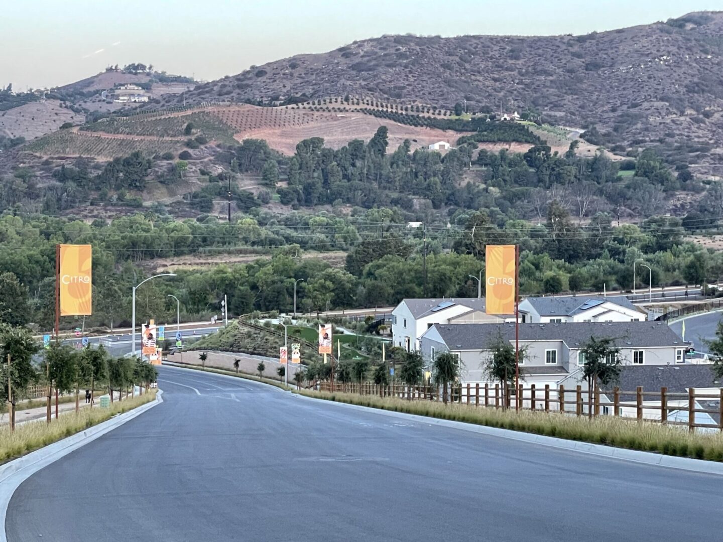 A road with trees and hills in the background