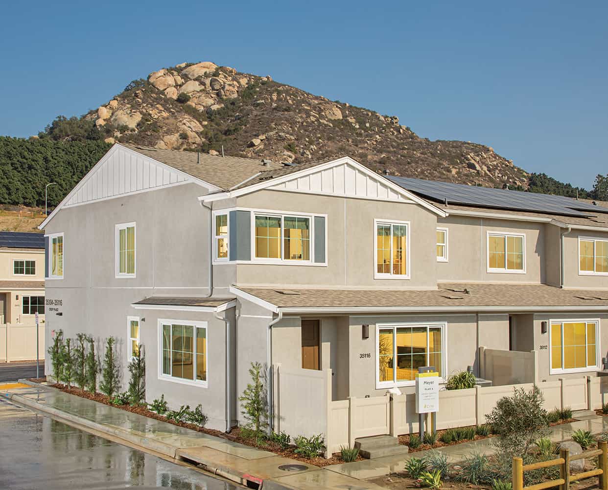 A house with a mountain in the background.