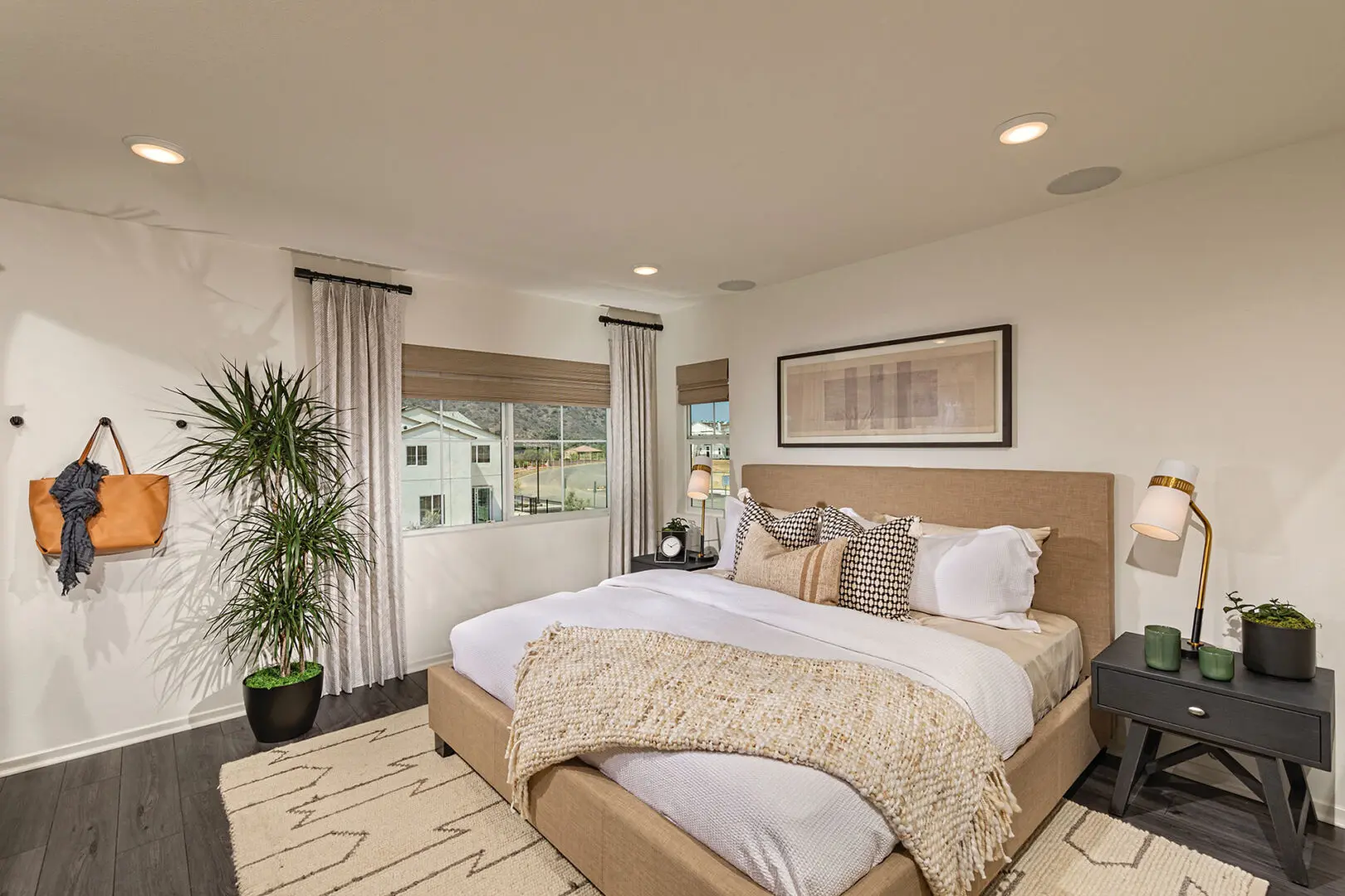 A bedroom with a bed, nightstand and window.