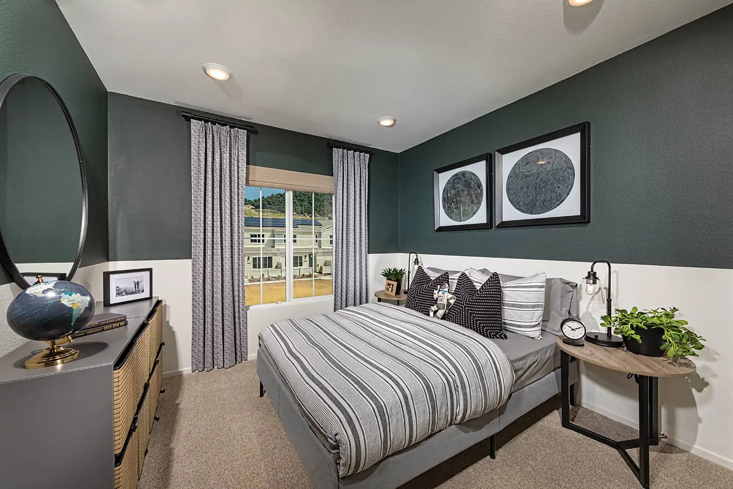 A bedroom with a bed, dresser and window.