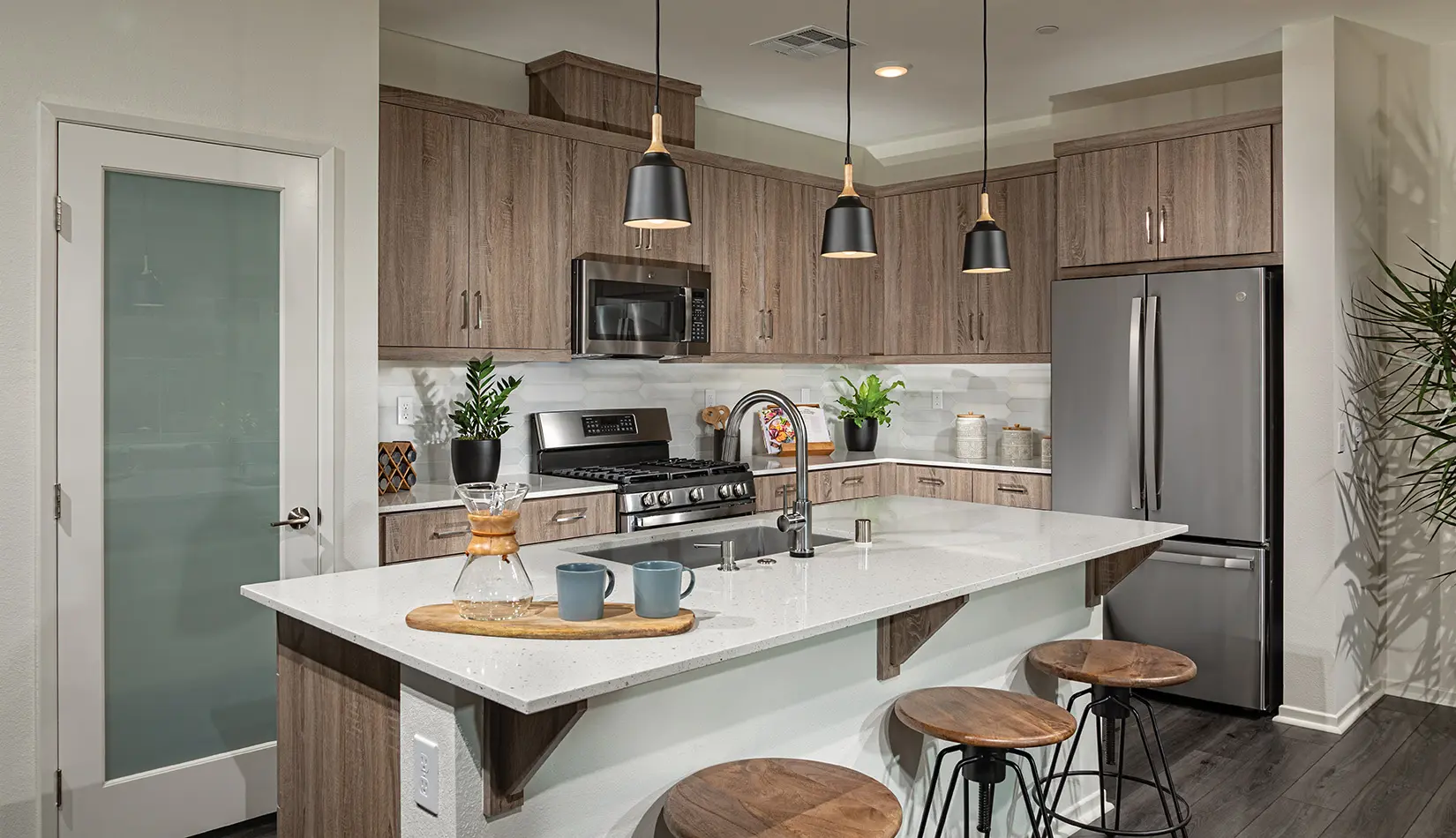 A kitchen with wooden cabinets and white counters.