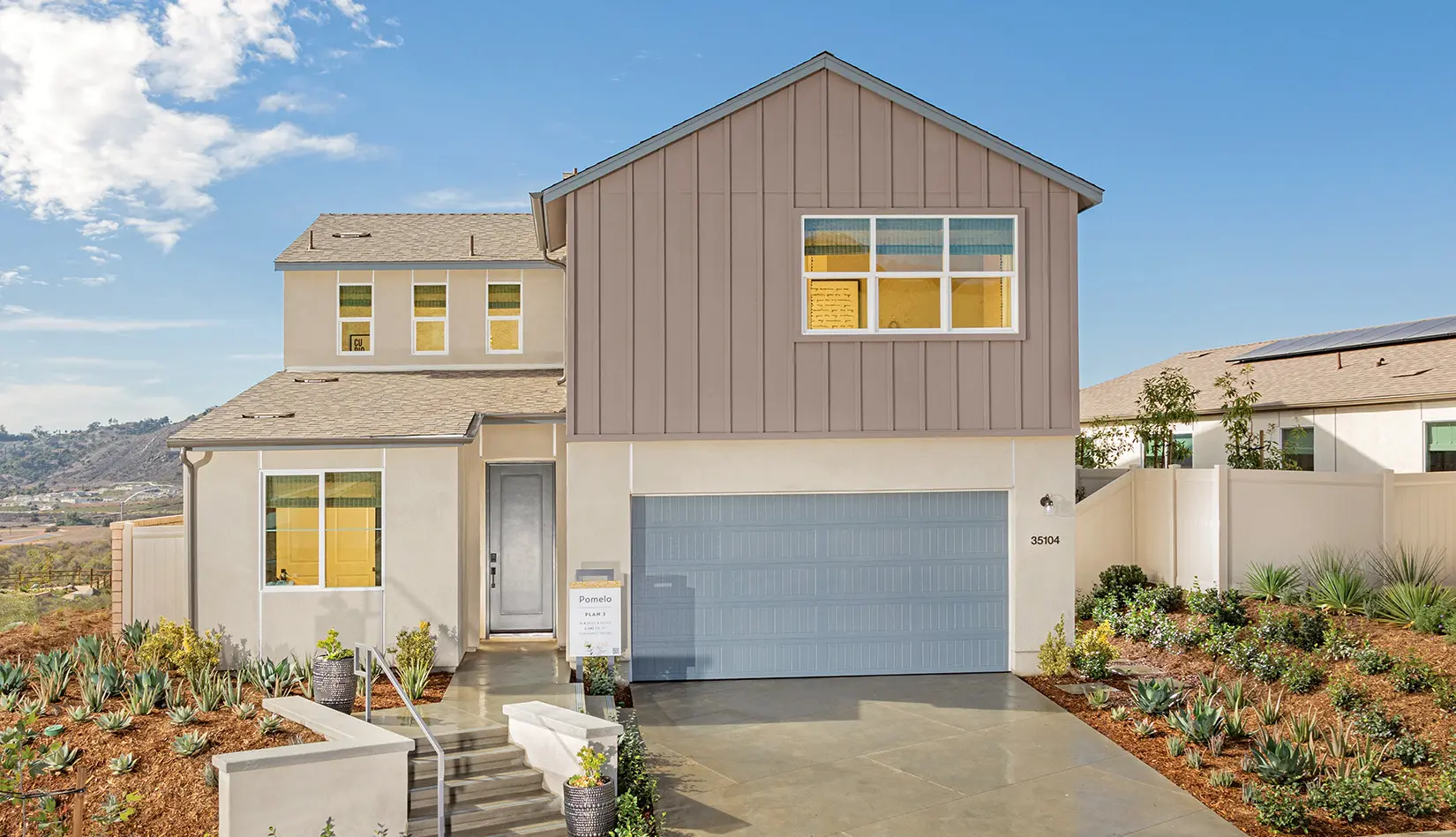 A house with a garage and steps leading to it.