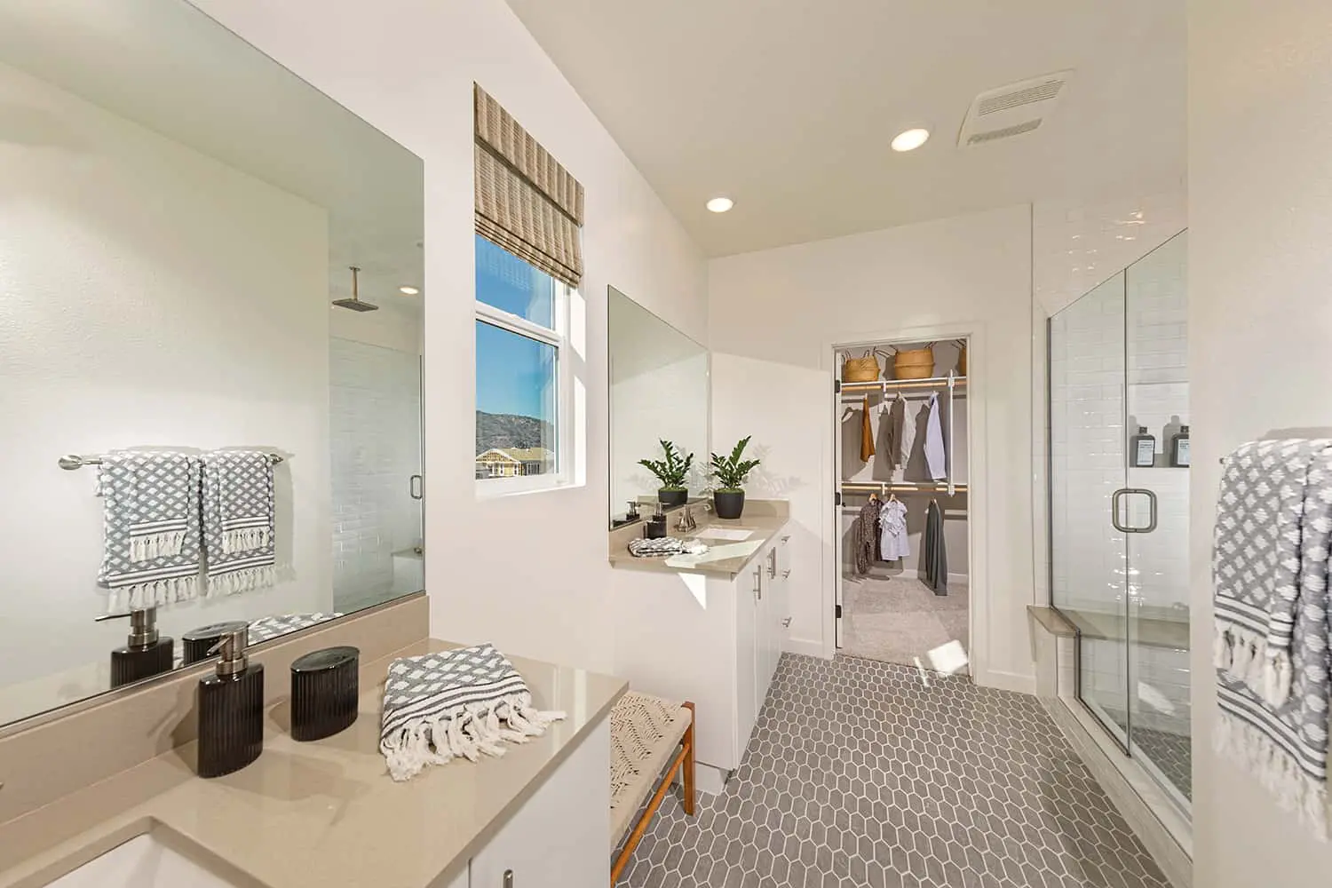 A bathroom with a sink, mirror and cabinets.