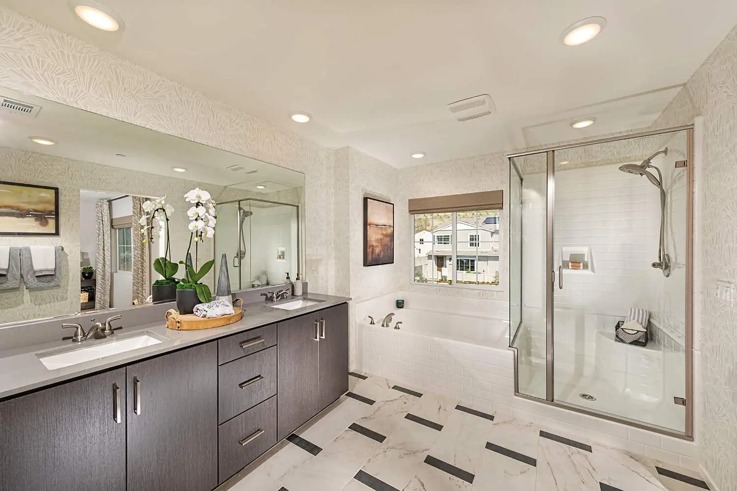 A bathroom with a large tub and separate shower.