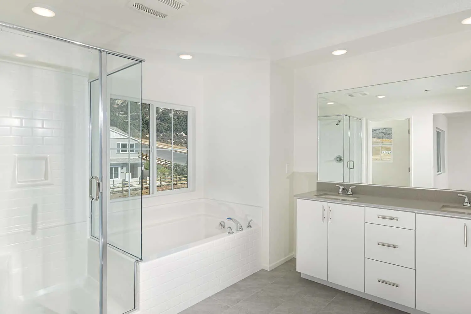 A bathroom with white walls and tile floors.