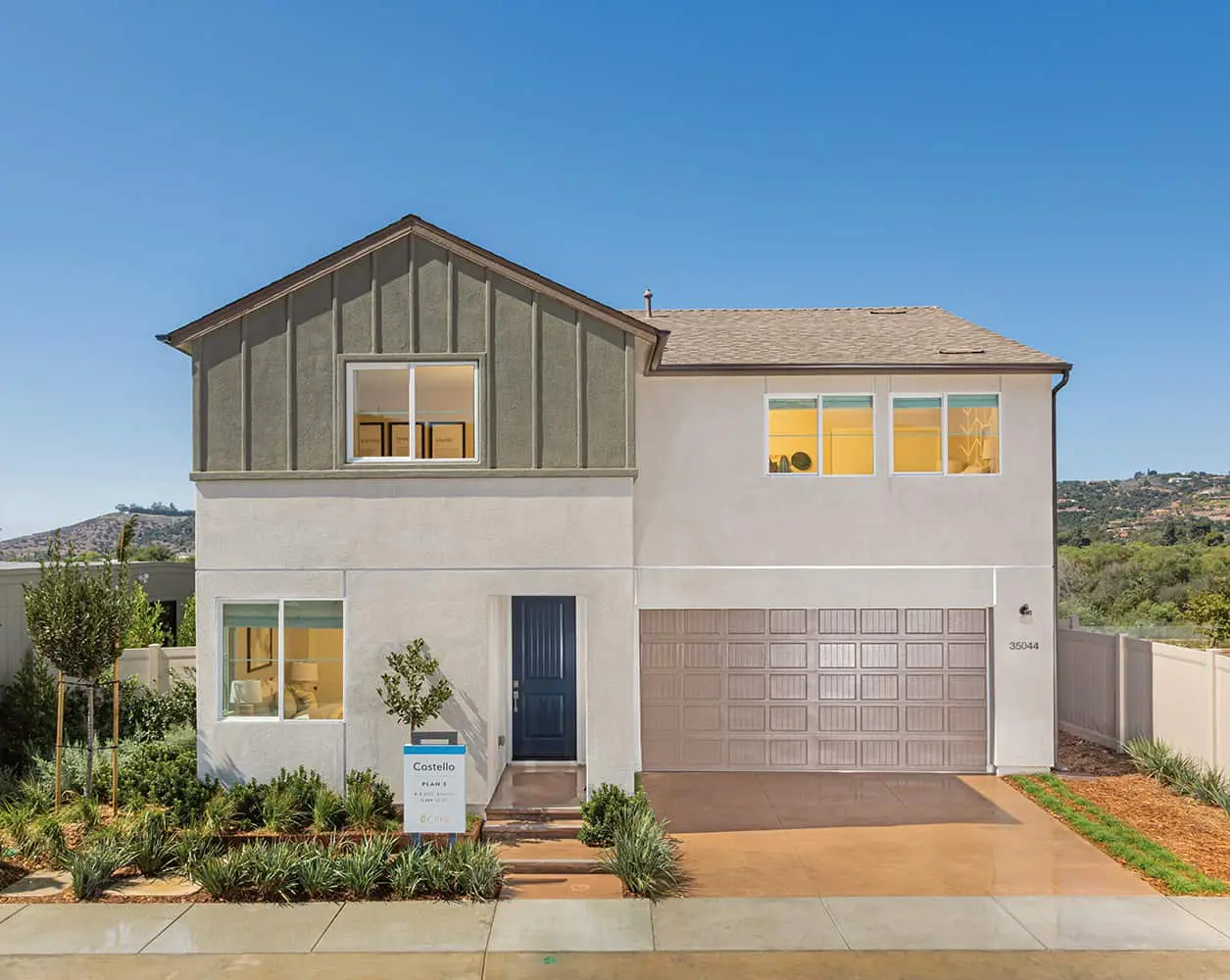 A large white house with a garage door.