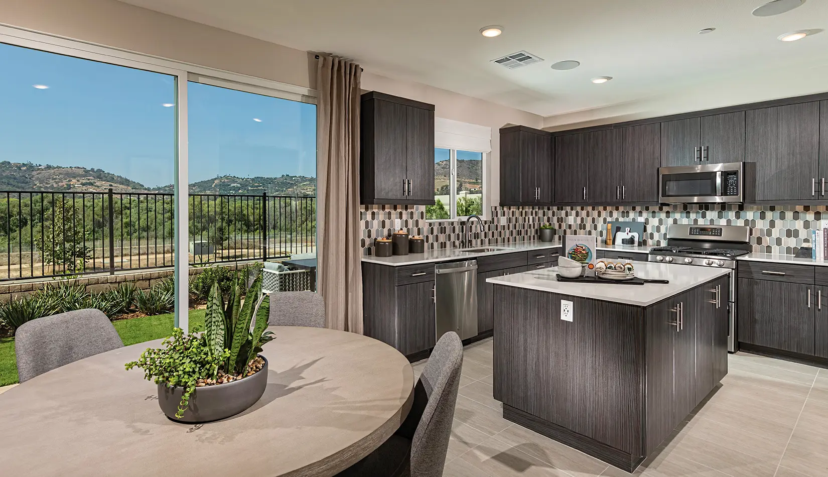 A kitchen with a table and chairs in it