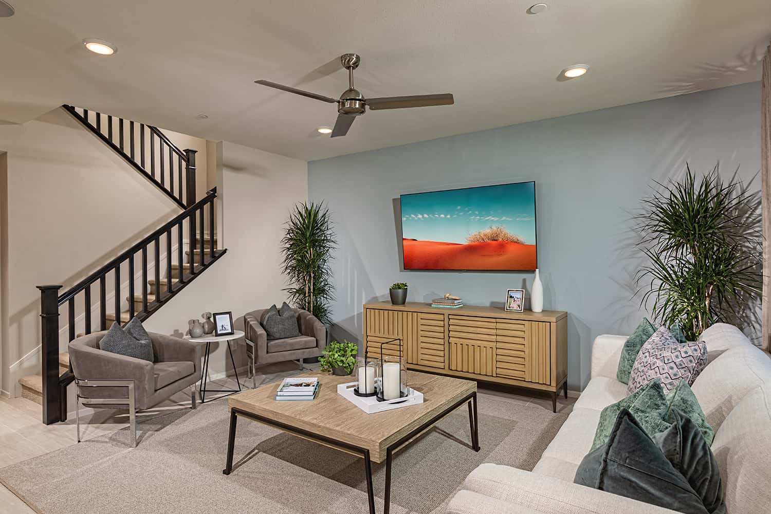 A living room with couches, chairs and tables.