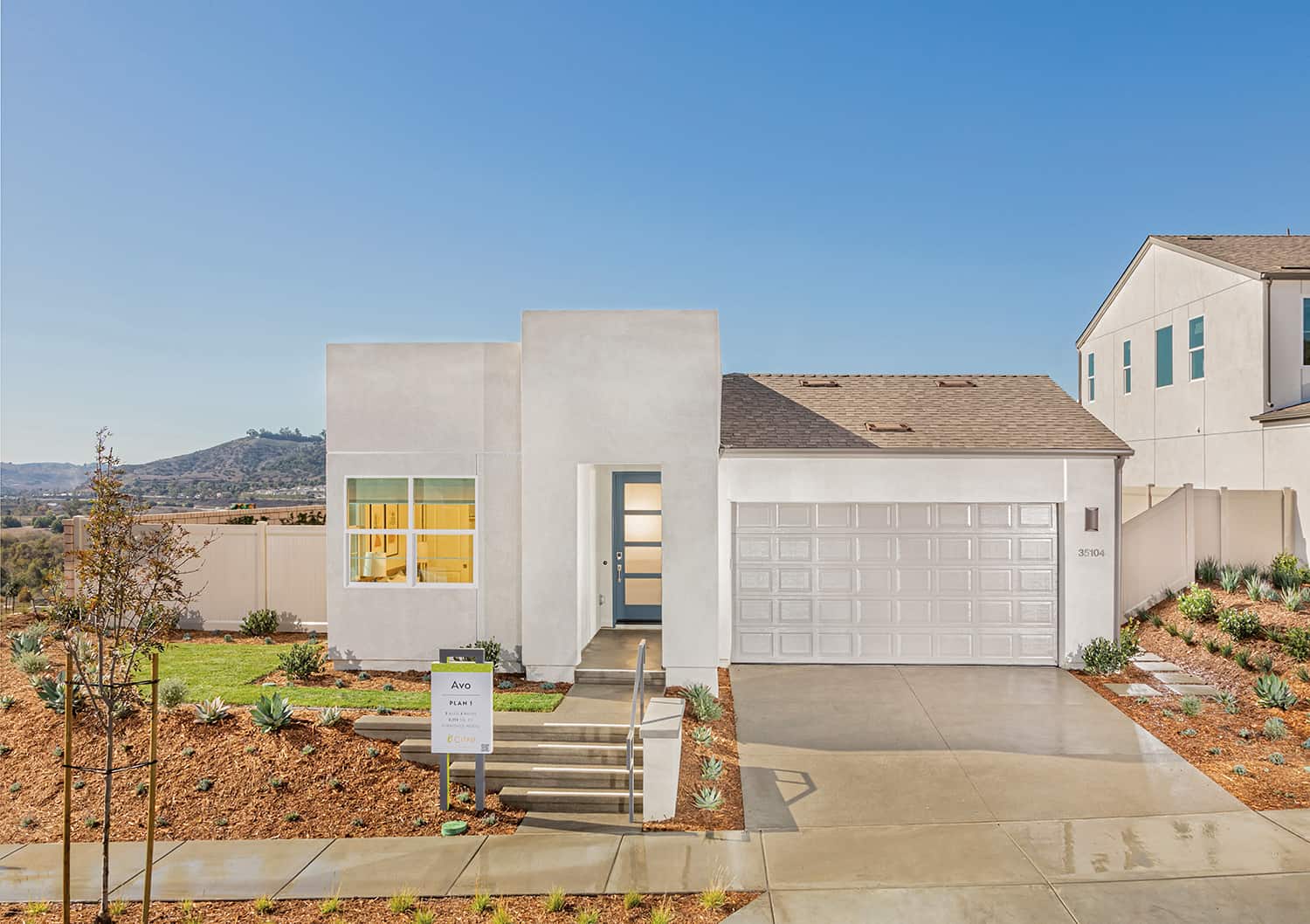 A white house with a driveway and garage.