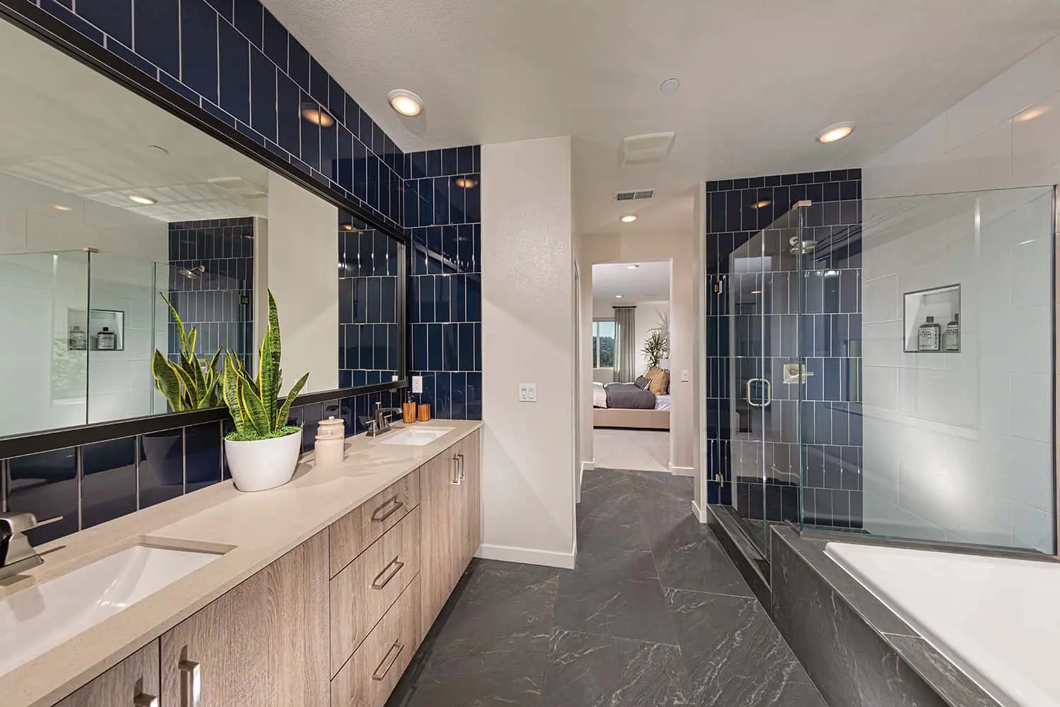 A bathroom with a large mirror and a tub