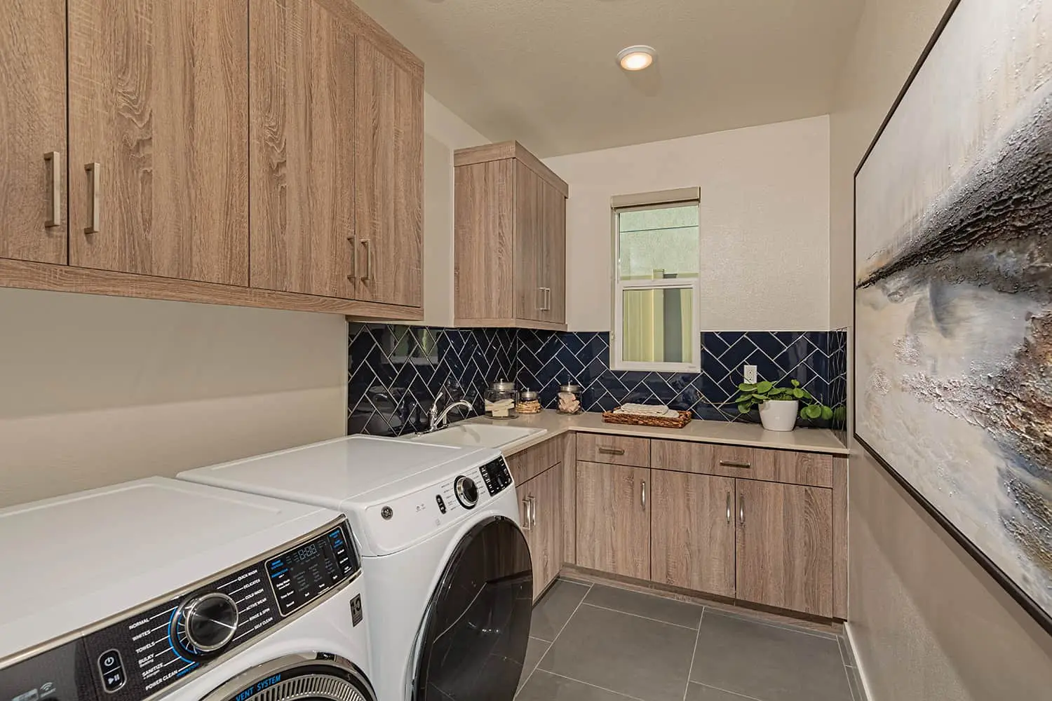 A laundry room with wooden cabinets and white appliances.