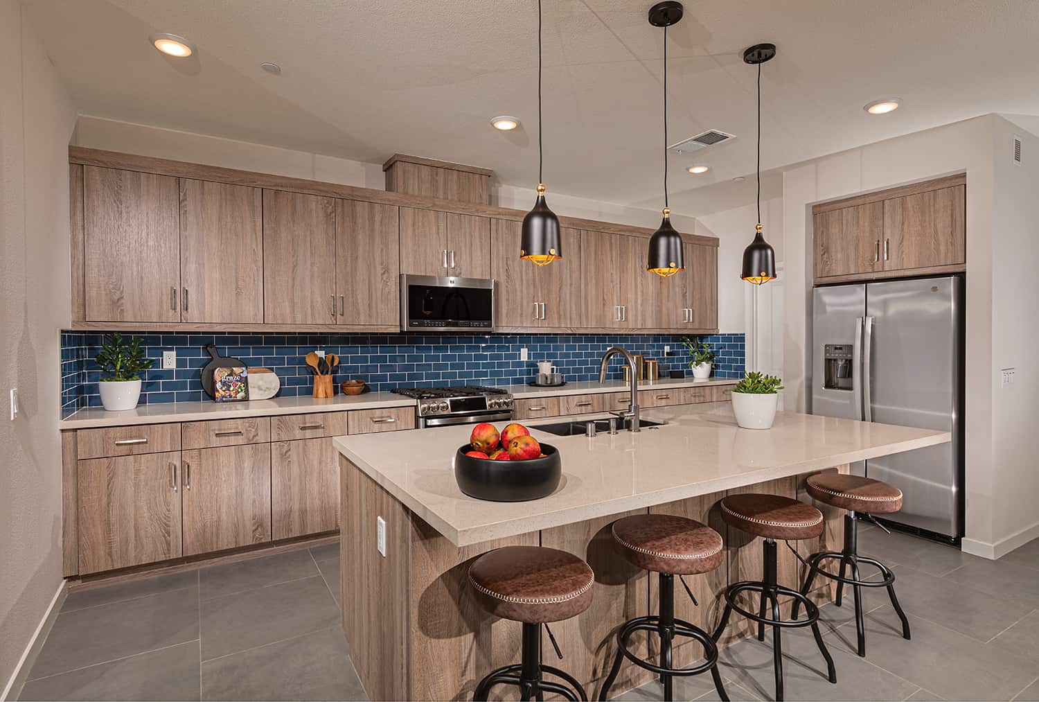 A kitchen with wooden cabinets and an island.