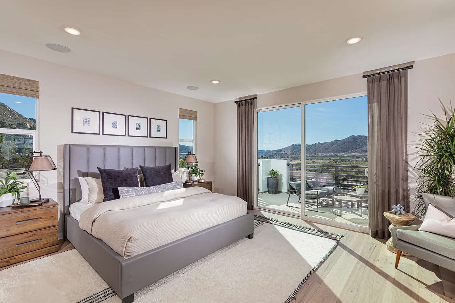 A bedroom with a large window and a view of the mountains.