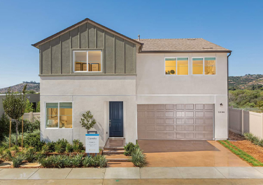 A large white house with a garage door.