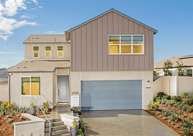 A house with a garage and steps leading to it.